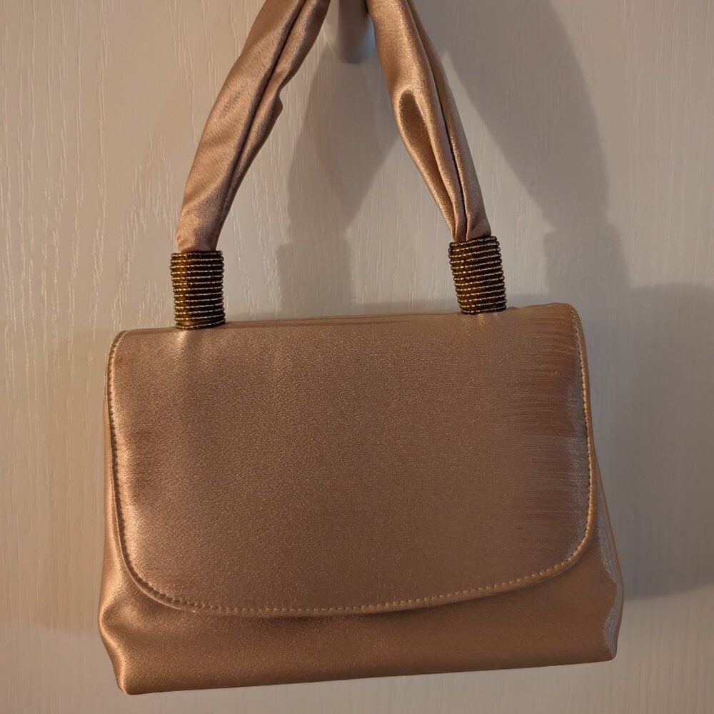 Gold Shoulder Bag with Braided Handles and Flap Closure